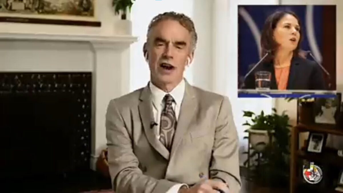 Jordan Peterson speaking into a camera, wearing a suit. There is also a picture of Annalena Baerbock, the German Foreign Minister, in the upper right corner.