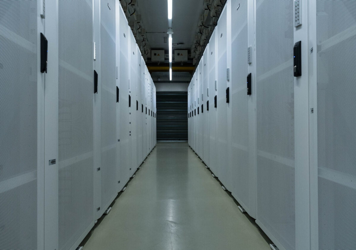 Picture of a server room at SAP, a narrow corridor, large computer boxes to the left and right.