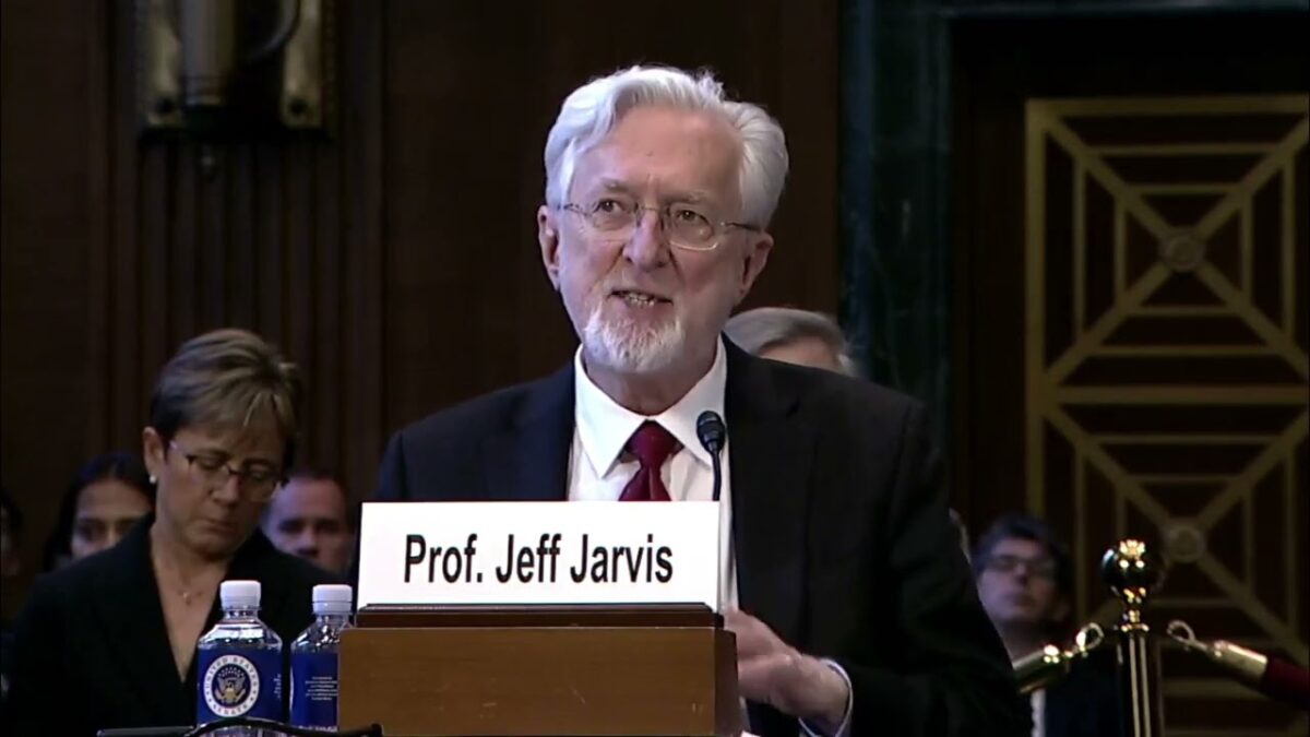 Screenshot of Jeff Jarvis in front of the senate speaking.