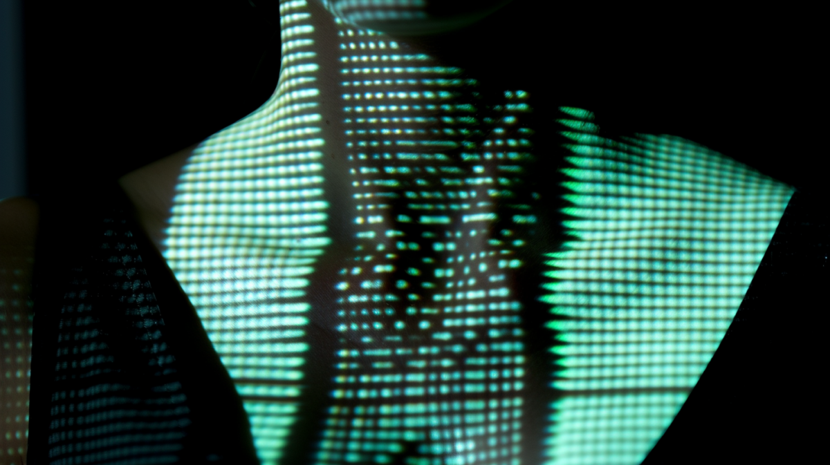 the silhouette of a woman emergine from a vertical stack of bright green and white horizontal lines against black background, glowing green
